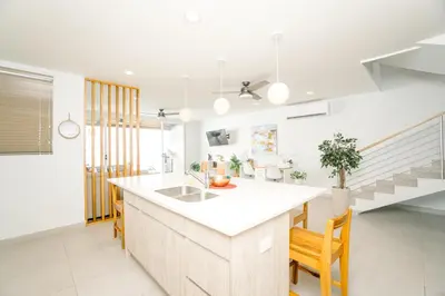 a kitchen with a sink and a counter top at Casa Lapa Roja in Playa Hermosa