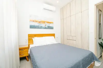 a bedroom with a bed with a wooden headboard at Casa Lapa Roja in Playa Hermosa