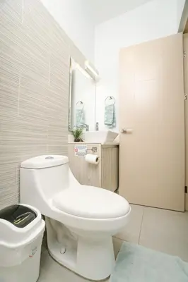 a bathroom with a white toilet and a sink at Casa Lapa Roja in Playa Hermosa