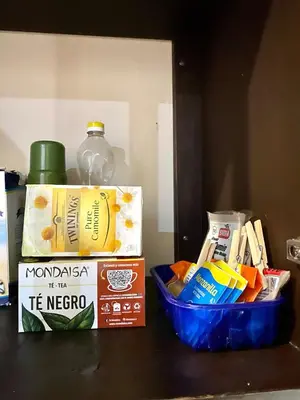 a shelf with a basket of food and a bottle of alcohol at Jaco Hideaway Oasis in Jacó