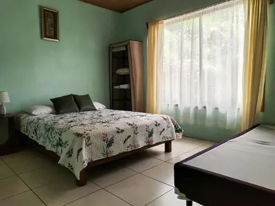a bedroom with a bed and a window at Casa Beli in Monteverde Costa Rica