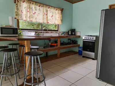 a kitchen with a counter and some bar stools at Casa Beli in Monteverde Costa Rica