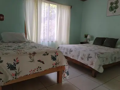 a bedroom with two beds and a window at Casa Beli in Monteverde Costa Rica