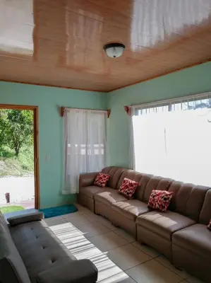 a living room with a couch and a window at Casa Beli in Monteverde Costa Rica