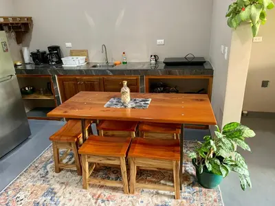a wooden table and chairs in a kitchen at Verde Amanecer in Bijagua