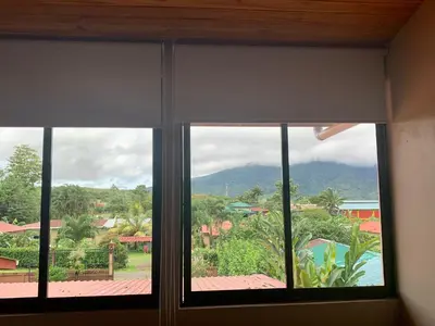 a window with a view of a mountain at Verde Amanecer in Bijagua