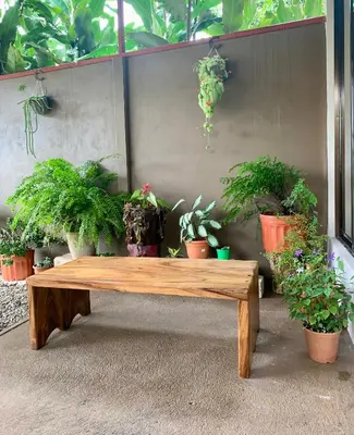 a wooden bench with a bunch of potted plants at Verde Amanecer in Bijagua