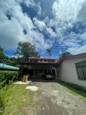 a house with a car parked in front of it at Verde Amanecer in Bijagua
