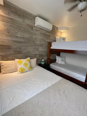 two bunk beds in a room with a wall at Casa Encanto Luz del Mar, Con Piscina Privada in Herradura