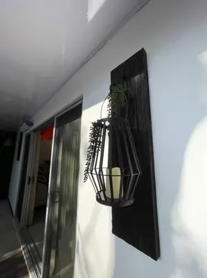 a plant in a hanging basket on a wall at Casa Encanto Luz del Mar, Con Piscina Privada in Herradura