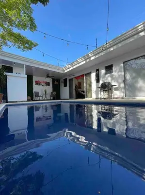 a large swimming pool in front of a building at Casa Encanto Luz del Mar, Con Piscina Privada in Herradura