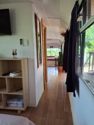 a hallway of a tiny house with a window at Casa Bus los Guanacastes in Veintisiete de Abril