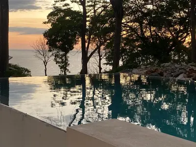 a swimming pool with a view of the water at Villa Laia - Santa Teresa in Santa Teresa Beach