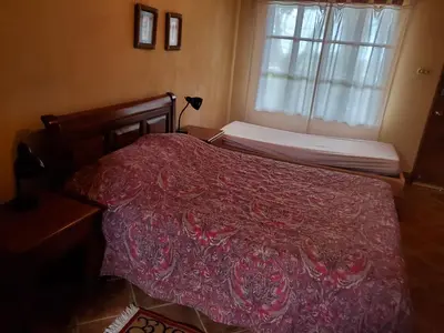 a bedroom with a bed with a red blanket and a window at PACIFIC VISTA, Panoramic Beach & Ocean Views in Sámara