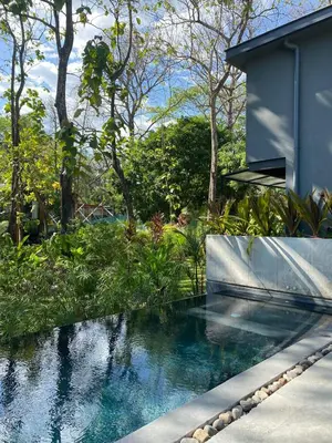 a swimming pool in front of a house at Studio Aloha - Malpais in Carmen