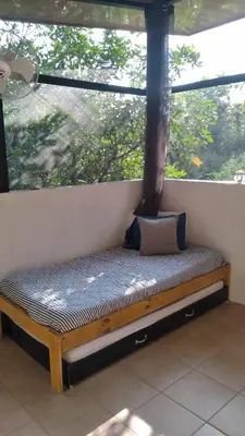 a bench in front of a window in a room at Cabinas fave in Uvita