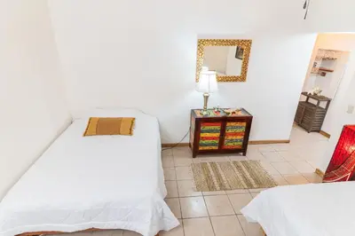 a bedroom with two beds and a table with a mirror at Hacienda La Norma Boho Boutique Hotel in Veintisiete de Abril
