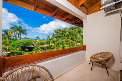 a balcony with two chairs and a view of the ocean at Villa Flamingo 8 At Playa Flamingo in Playa Flamingo
