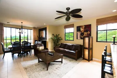 a living room with a couch and a ceiling fan at Classy artsy ocean-view unit near pool at Pacifico in Coco sleeps 6 in Coco