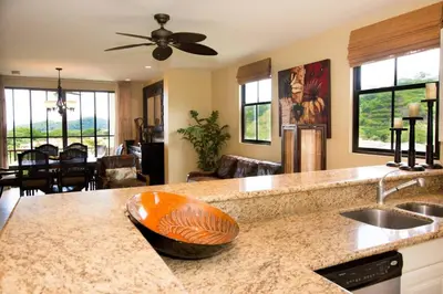 a kitchen with a sink and a counter with a bowl at Classy artsy ocean-view unit near pool at Pacifico in Coco sleeps 6 in Coco