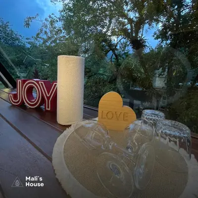 a table with two candles and a toy motorcycle on it at Mali's House in Fortuna