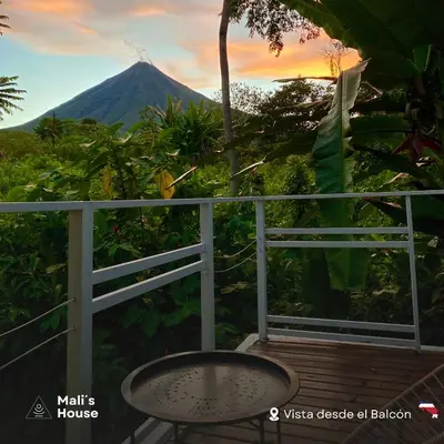 a table on a balcony with a view of a mountain at Mali's House in Fortuna