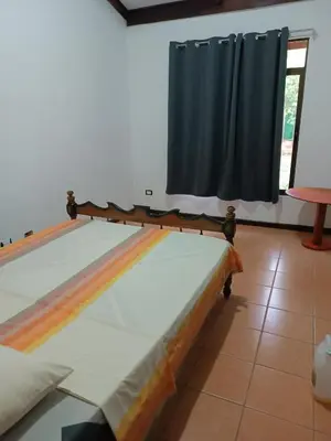 a bed in a room with a window at House Manantial de Vida in Nandayure
