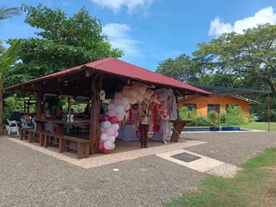 a woman standing in front of a tent with balloons at House Manantial de Vida in Nandayure