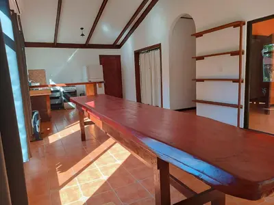a large wooden table in a living room at House Manantial de Vida in Nandayure