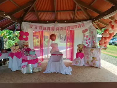a pink and white birthday party with teddy bears and balloons at House Manantial de Vida in Nandayure