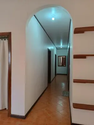 a hallway with white walls and a glass ceiling at House Manantial de Vida in Nandayure