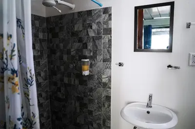 a bathroom with a sink and a mirror at House in the palm forest in Carrillo