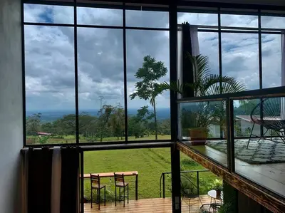 a room with a large window with a table and chairs at Villa Aura in Fortuna