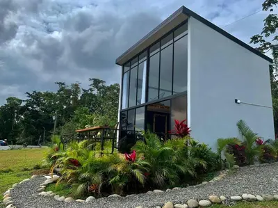 a small house with glass windows and plants at Villa Aura in Fortuna