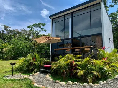 a house with an umbrella and some plants at Villa Aura in Fortuna