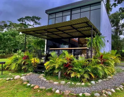a house with a garden in front of it at Villa Aura in Fortuna