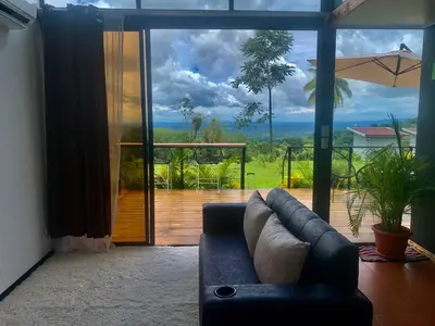 a living room with a couch and a large glass door at Villa Aura in Fortuna