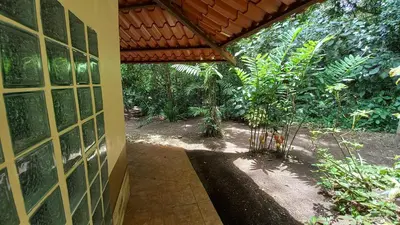 an outside entrance to a house with a garden at Cosy Apartment near the Lake in Tilarán