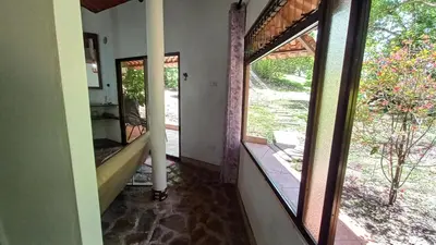 a hallway with two large windows and a staircase at Cosy Apartment near the Lake in Tilarán