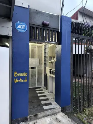 an entrance to a building with a blue gate at Edificio El Barrio Vertical in San José