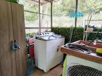 a washing machine sitting inside of a greenhouse at La casita JSL in Ramos