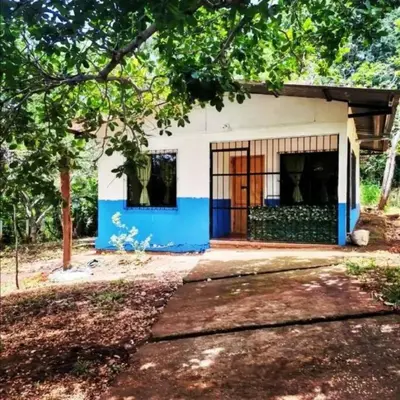 a small house with a blue and white facade at La casita JSL in Ramos