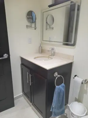 a bathroom with a sink and a mirror at Lakeview Arenal Suite - 2025-2026 Traveller Award Winners in Tronadora