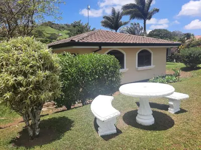 a white table and bench in front of a house at Lakeview Arenal Suite - 2025-2026 Traveller Award Winners in Tronadora