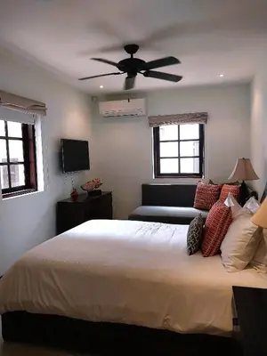 a bedroom with a bed with a ceiling fan at Las Catalinas - Studio Cazenovia centrally located, short walk to beach in Playa Danta