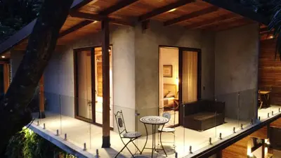 a house with a balcony with a table and chairs at ARjAU Boutique Hotel - Adults Only in Santa Teresa Beach