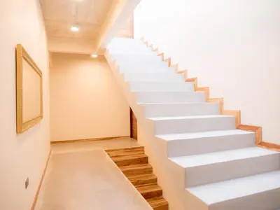 a white staircase in a room with a picture on the wall at ARjAU Boutique Hotel - Adults Only in Santa Teresa Beach