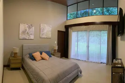 a bedroom with a bed and a large window at Villa Lapa in Agujas