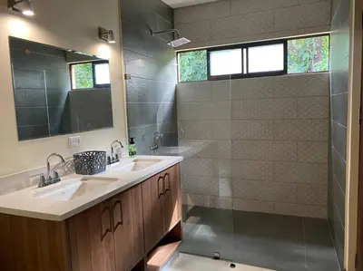 a bathroom with two sinks and a shower at Villa Lapa in Agujas