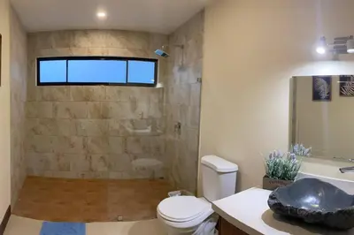 a bathroom with a shower and a toilet and a sink at Villa Lapa in Agujas